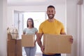 Portrait Of Couple Carrying Boxes Through Front Door Of New Home On Moving Day Royalty Free Stock Photo