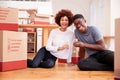 Portrait Of Couple Celebrating Moving Into New Home Drinking Champagne Royalty Free Stock Photo