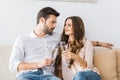 portrait of couple clinking glasses of champagne on sofa Royalty Free Stock Photo