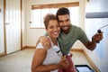 Portrait Of Couple Decorating Room In New Home Painting Wall Together Royalty Free Stock Photo