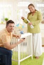 Portrait of couple fixing baby bed