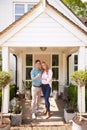 Portrait Of Couple Holding Keys To New Home Standing Outside Front Door Royalty Free Stock Photo