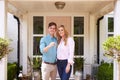 Portrait Of Couple Holding Keys To New Home Standing Outside Front Door Royalty Free Stock Photo