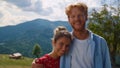 Portrait couple looking camera in mountain. Happy pair enjoying summer vacation. Royalty Free Stock Photo