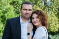 Portrait of a couple in love. A Middle Eastern man in a business suit with his curly-haired wife in a black dress Royalty Free Stock Photo