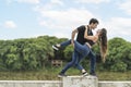 Portrait of couple of lovers dancing happily on the railing of the waterfront