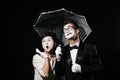 Portrait of couple mime on black background. Royalty Free Stock Photo