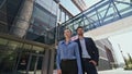 Portrait couple office employees outside contemporary office building zoom in. Royalty Free Stock Photo