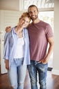 Portrait Of Couple By Open Front Door In Lounge Of New Home Royalty Free Stock Photo