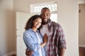 Portrait Of Couple By Open Front Door In Lounge Of New Home Royalty Free Stock Photo