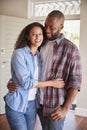 Portrait Of Couple By Open Front Door In Lounge Of New Home Royalty Free Stock Photo