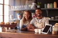 Portrait Of Couple Running Coffee Shop Behind Counter