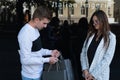 Portrait of couple with shopping bags in the city. Girl displeased looking at boyfriend shopping. Lovers quarreled Royalty Free Stock Photo