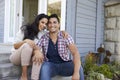 Portrait Of Couple Sitting On Steps Outside Home