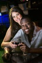 Portrait of couple smiling and toasting their wine glasses at bar counter Royalty Free Stock Photo