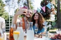 Portrait of couple taking selfie, sitting at the table with family and friends at the family garden party. Royalty Free Stock Photo