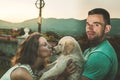Portrait of a couple with their adorable puppy dog Royalty Free Stock Photo