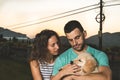 Portrait of a couple with their adorable puppy dog Royalty Free Stock Photo