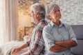 Portrait of couple of two old seniors arguing and looking other sides after fighting. Woman and man back to back tired and Royalty Free Stock Photo