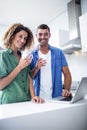 Portrait of couple using laptop while having a cup of coffee Royalty Free Stock Photo