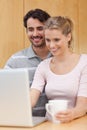 Portrait of a couple using a notebook Royalty Free Stock Photo