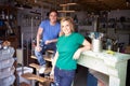 Portrait Of Couple In Workshop Upcycling And Working On Fire Surround