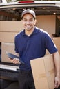 Portrait Of Courier With Digital Tablet Delivering Package Royalty Free Stock Photo