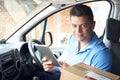 Portrait Of Courier In Van With Digital Tablet Delivering Package To House Royalty Free Stock Photo