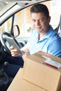 Portrait Of Courier In Van With Digital Tablet Delivering Package To House Royalty Free Stock Photo