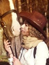 Portrait of cowgirl with her red horse. Royalty Free Stock Photo