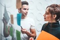 Portrait of coworkers standing at office space behind glass wall with sticky notes Royalty Free Stock Photo