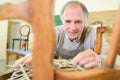 Portrait craftsman in workshop man upholstering chair