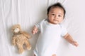 Portrait of a crawling baby on the bed in her room, Adorable baby boy in white sunny bedroom, Newborn child relaxing in bed, Nurse Royalty Free Stock Photo