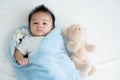 Portrait of a crawling baby on the bed in her room, Adorable baby boy in white sunny bedroom, Newborn child relaxing in bed, Nurs Royalty Free Stock Photo