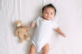 Portrait of a crawling baby on the bed in her room, Adorable baby boy in white sunny bedroom, Newborn child relaxing in bed Royalty Free Stock Photo