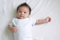 Portrait of a crawling baby on the bed in her room, Adorable baby boy in white sunny bedroom, Newborn child relaxing in bed Royalty Free Stock Photo