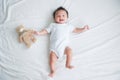 Portrait of a crawling baby on the bed in her room, Adorable baby boy in white sunny bedroom, Newborn child relaxing in bed Royalty Free Stock Photo