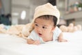 Portrait of a crawling baby on the bed in her room, Adorable baby boy in white sunny bedroom, Newborn child relaxing in bed Royalty Free Stock Photo