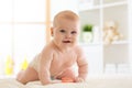 Portrait of a crawling baby on the carpet in bedroom