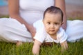 Portrait, crawling and baby with a mother in the park together during summer for bonding, care and playing. Kids, face