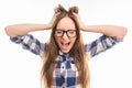 Portrait of crazy cute girl in glasses shouting and holding hair