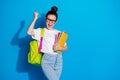 Portrait of crazy ecstatic girl hold many books copybooks backpack enjoy extra lecture courses win lottery raise fists