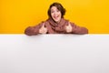 Portrait of crazy funky girl dressed brown sportswear on white placard empty space showing thumbs up isolated on yellow Royalty Free Stock Photo