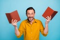 Portrait of crazy funky man hold paper books finish read adventure story enjoy wonder scream wear casual style clothing Royalty Free Stock Photo