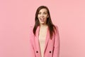 Portrait of crazy funny loony young woman in jacket with beveled eyes showing tongue isolated on pastel pink wall