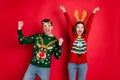 Portrait of crazy funny two family wife husband brown hair celebrate victory raise fists scream yes wear christmas tree