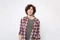 Portrait of crazy loony young man in casual clothes with beveled eyes and showing tongue isolated on white wall