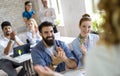 Portrait of creative business people team working together and smiling in office. Royalty Free Stock Photo