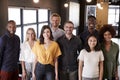 Portrait of a creative business team standing and smiling to camera in their office, elevated view Royalty Free Stock Photo