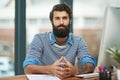 Portrait, creative and confident business man at desk in office by computer in startup company. Face, serious Royalty Free Stock Photo